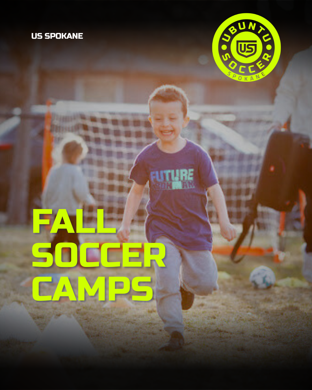 Young boy running and smiling on a soccer field during fall soccer camp, with a soccer goal and another child in the background, and the US LUBUNTU SOCCER SPOKANE logo in the corner.