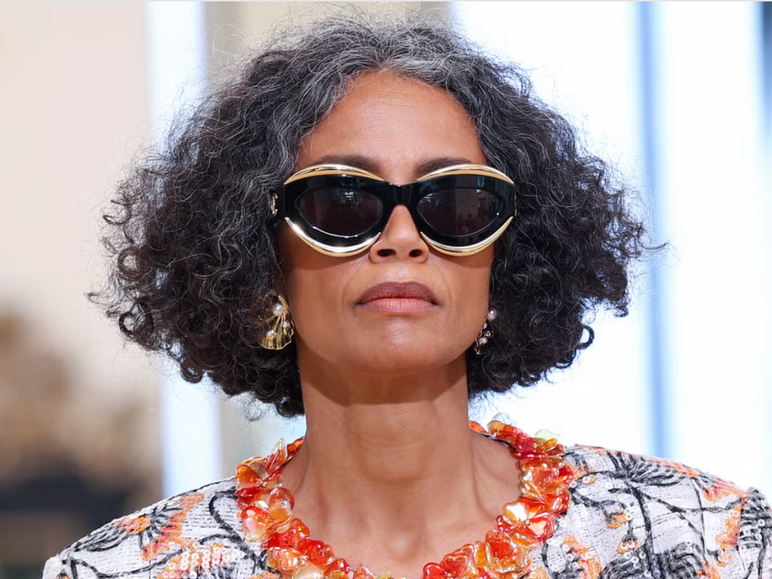 Woman with softly blended silver roots and glossy, natural-looking colour