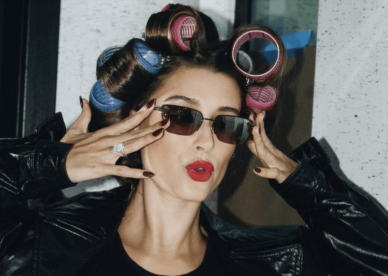 glamorous lady with big sunglasses and large rollers in her hair