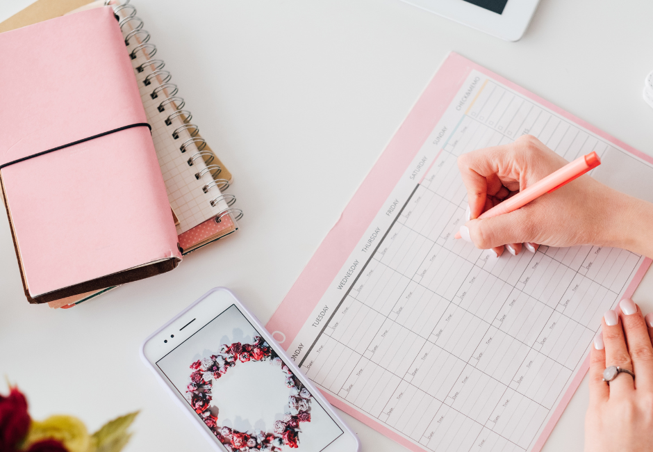 Woman's hand writing on calendar