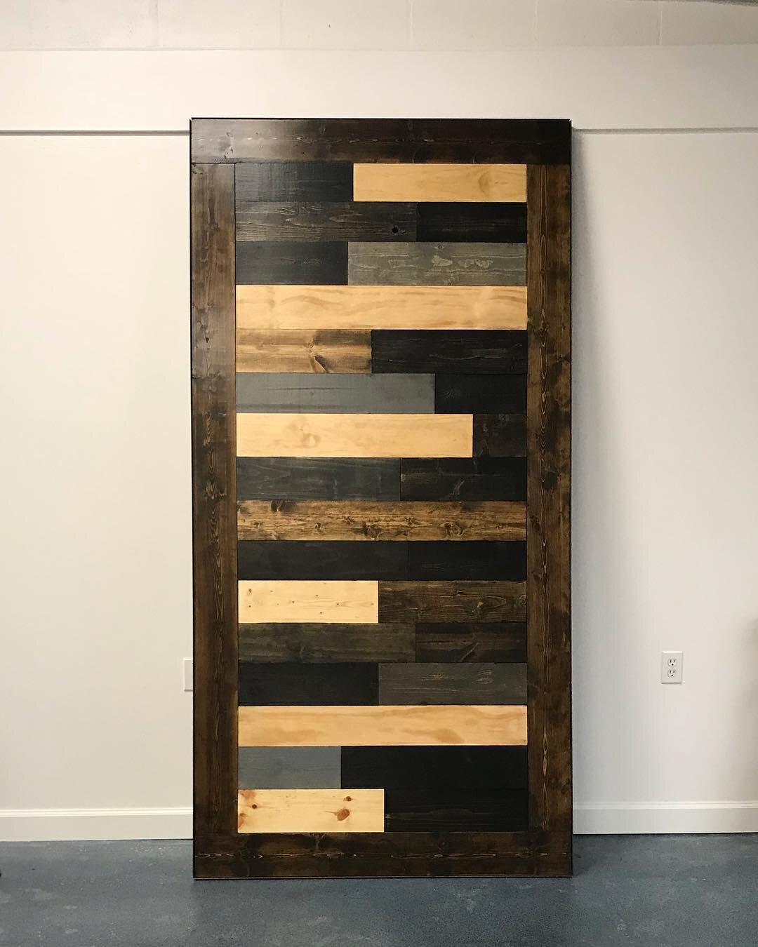 Undecided about what color door you want? Pick lots of colors! This staggered plank door looks so amazing with its dark walnut border and all of our speciality stain finishes. #barndoors