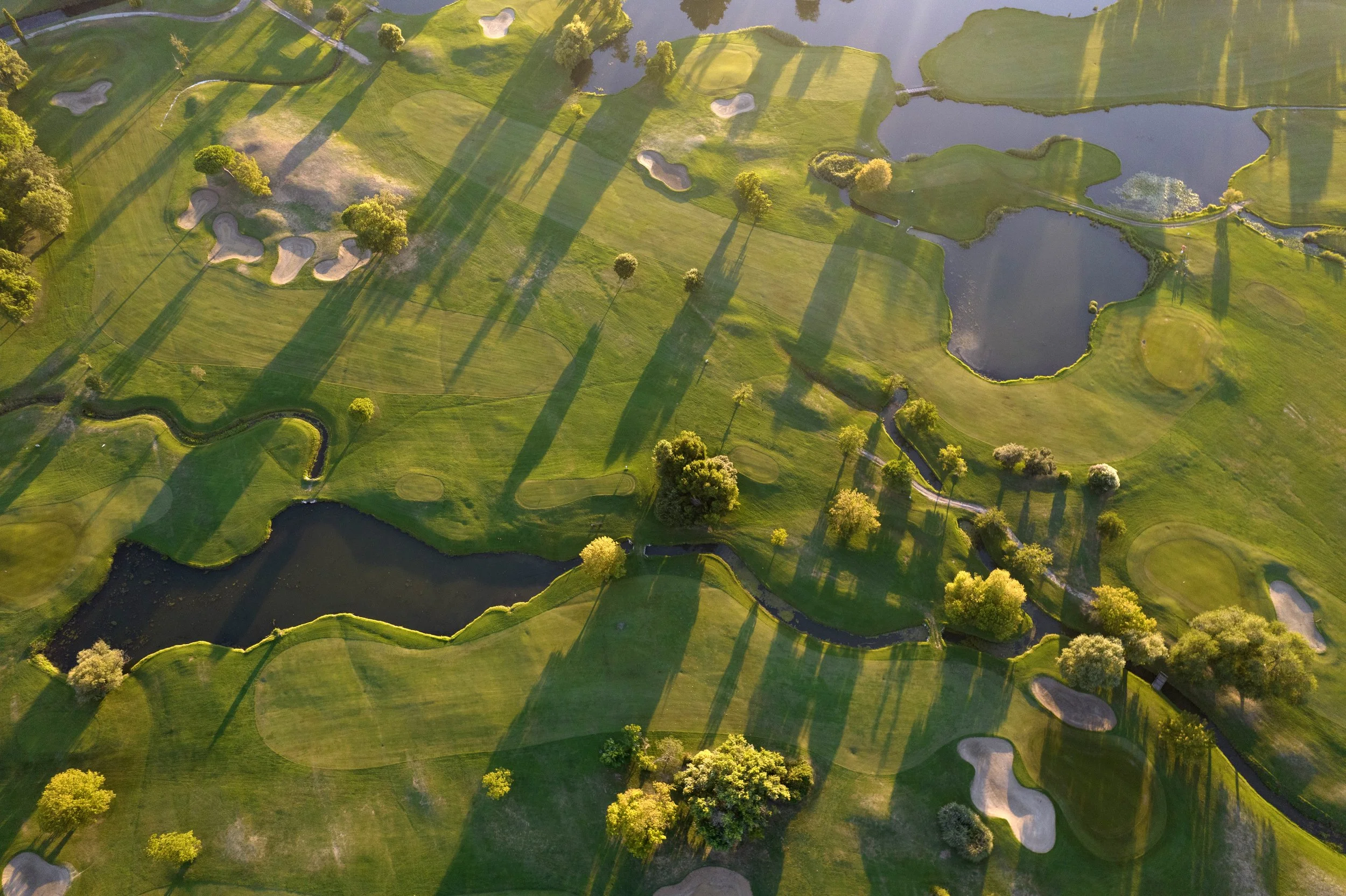 aerial-view-of-a-green-golf-course-at-sunset-2026-03-19-02-59-09-utc.jpg
