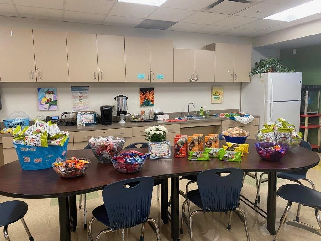 Photograph of the teacher's lounge with an assortment of snacks on a table.