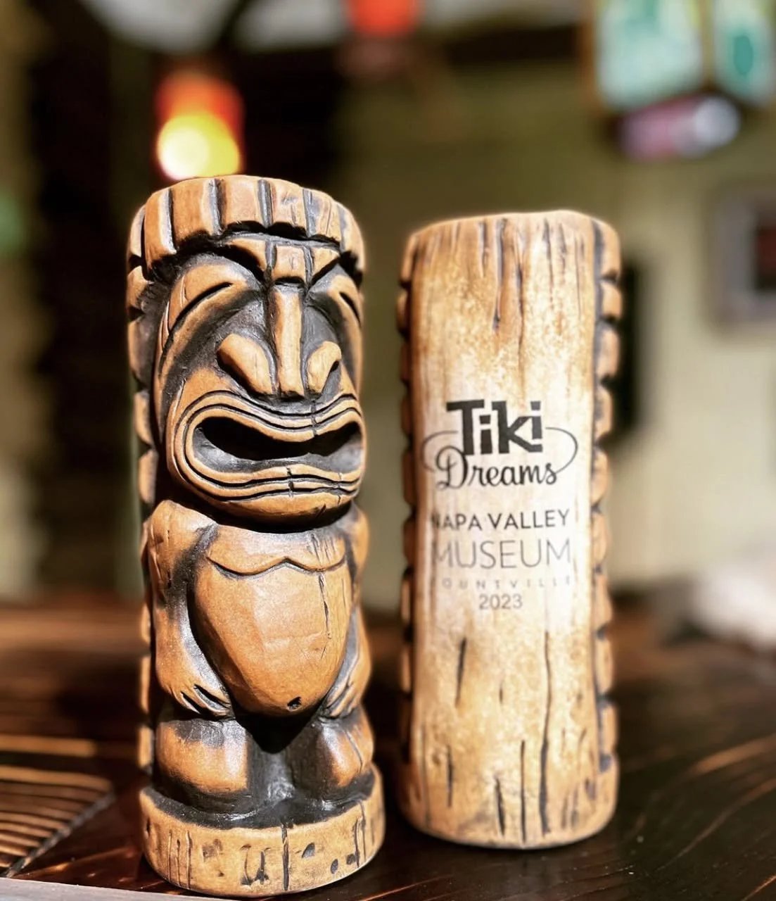 Wooden tiki sculpture and sign at Tiki Dreams Napa Valley Museum, 2023.