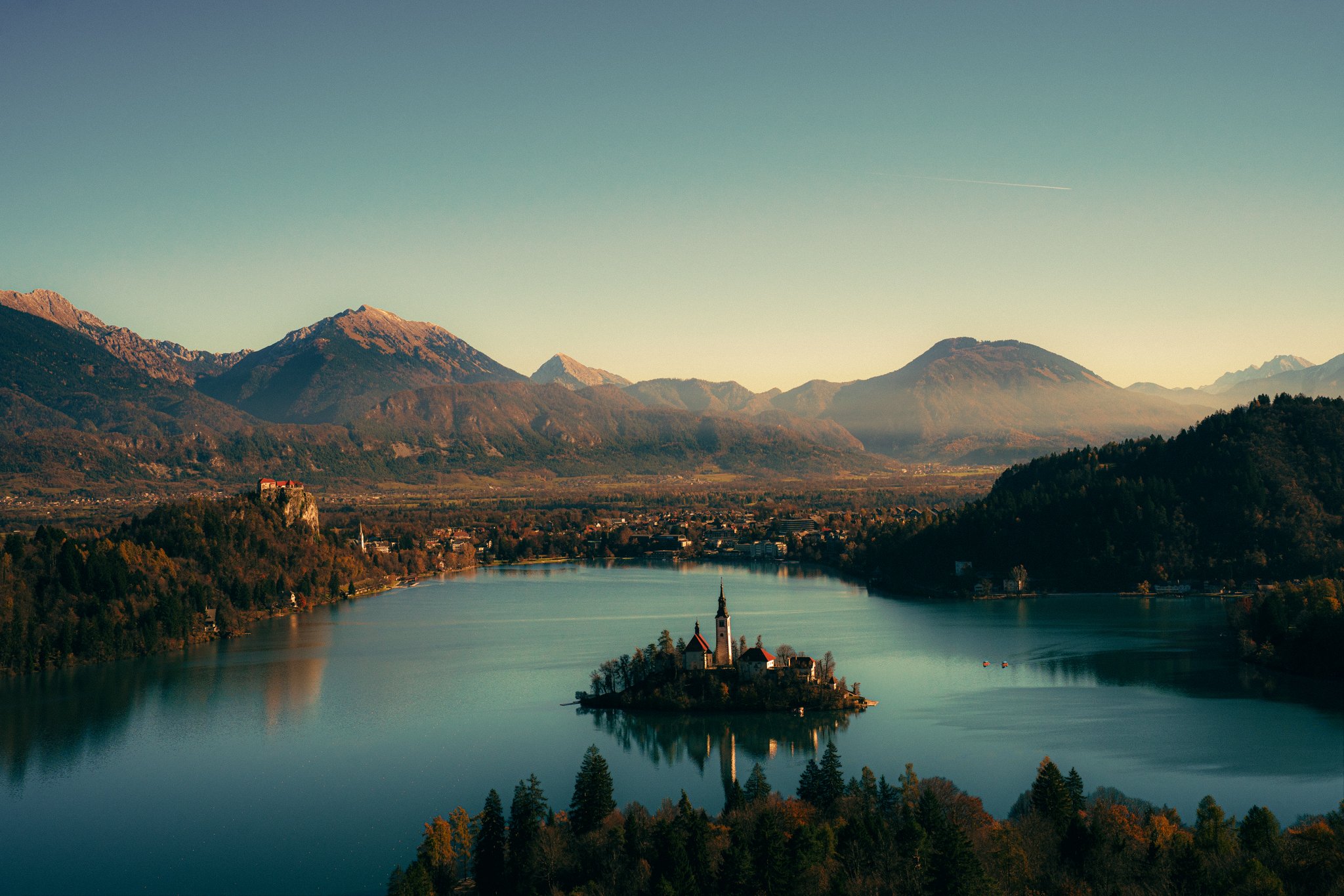 Lake, Bled - Slovenia. A lakeside church on an island with mountains in the background, during sunset.
