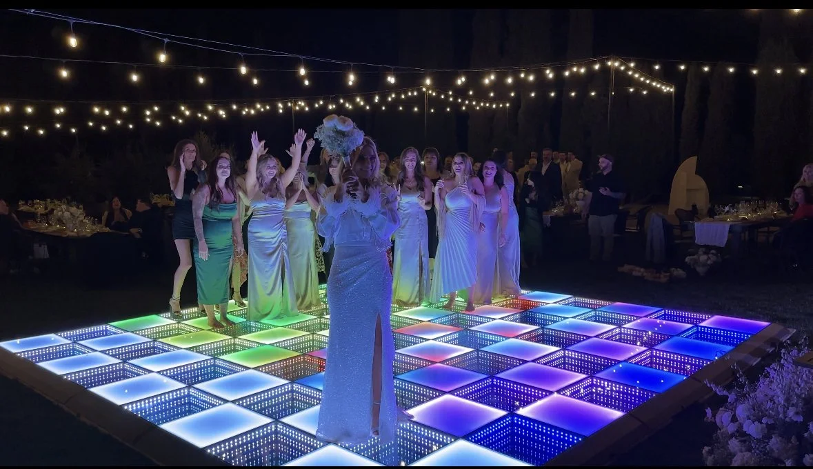 Dance floor installed under a large event tent for a wedding or corporate celebration.