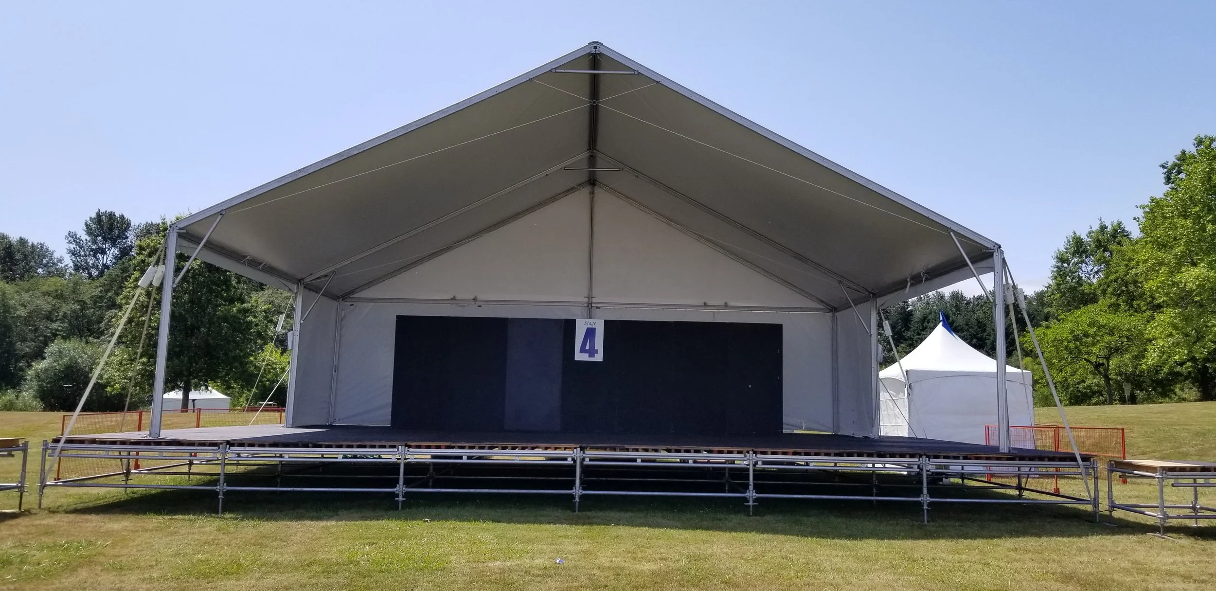 Covered event stage and temporary event structure