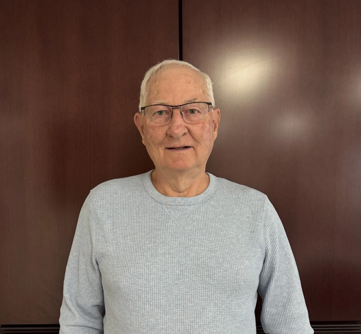 Logo of Central Valley Habitat for Humanity, featuring three blue figures holding up a green roof.