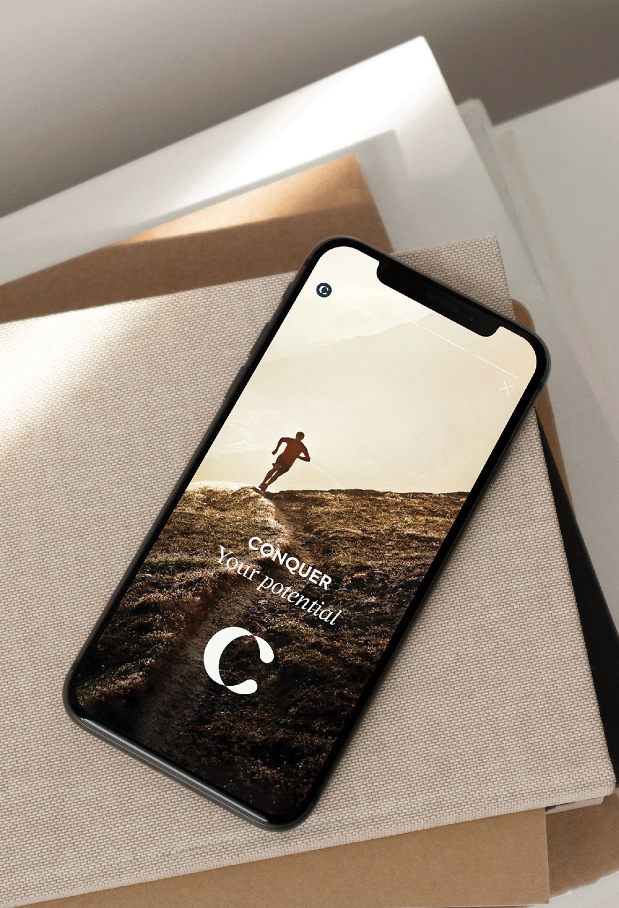 Image of smartphone with Conquer Health Instagram story mockup with logo and text that reads, 'Conquer your potential'
