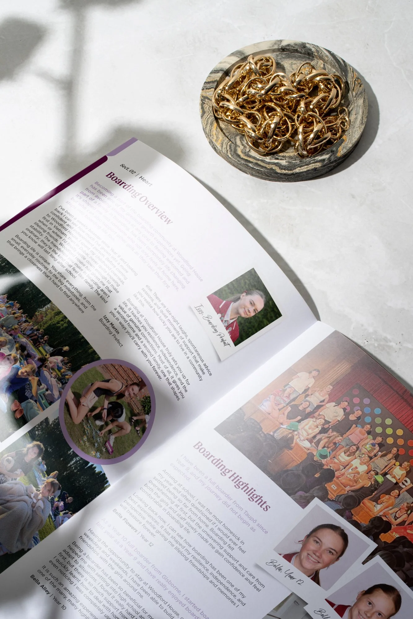Open spread of 2025 edition of Woodford House Chronicle with soft light, shadow and decorative dish of jewellery sitting alongside
