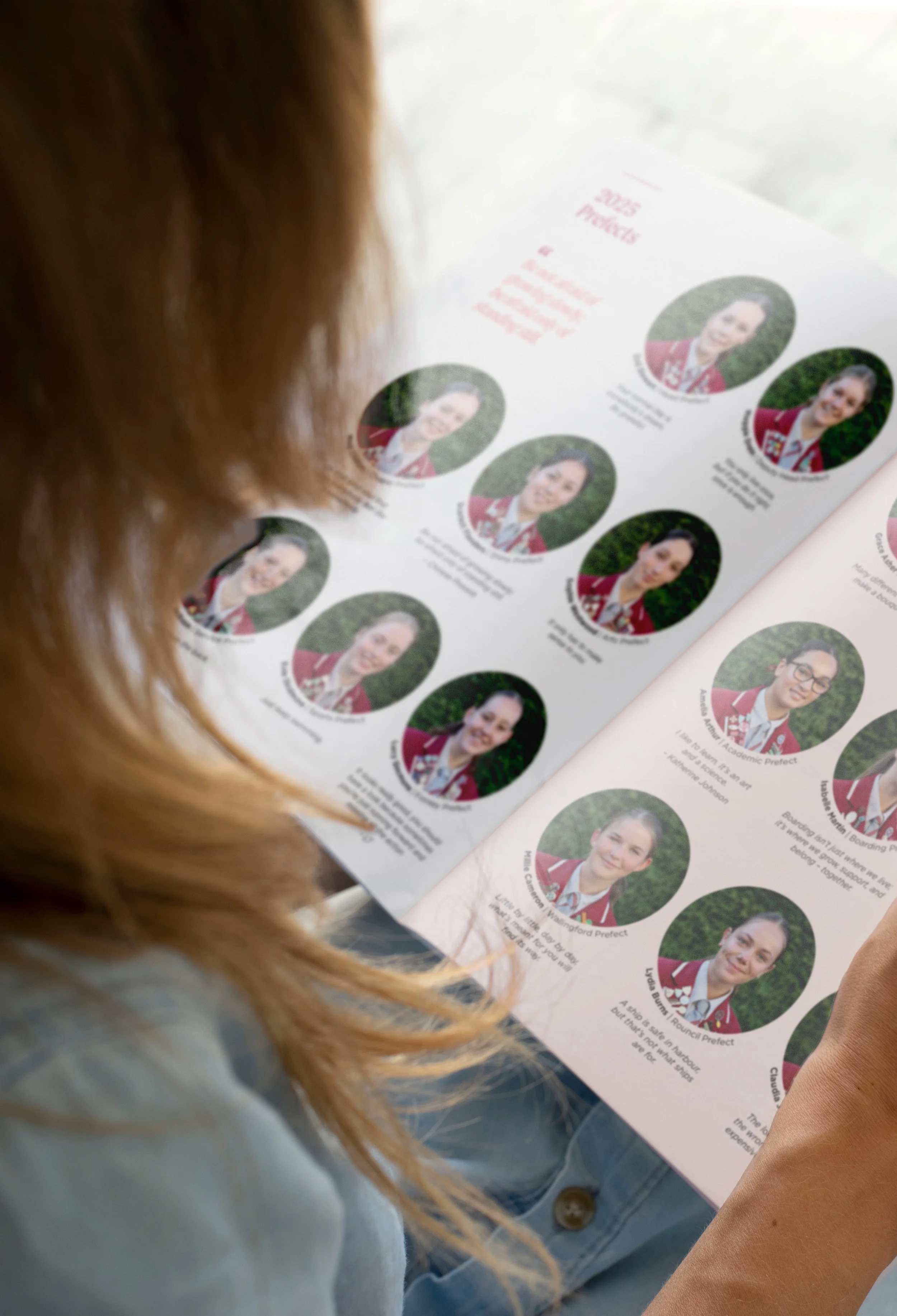 Close up image of young woman reading Prefects spread of 2025 edition of Woodford House Chronicle