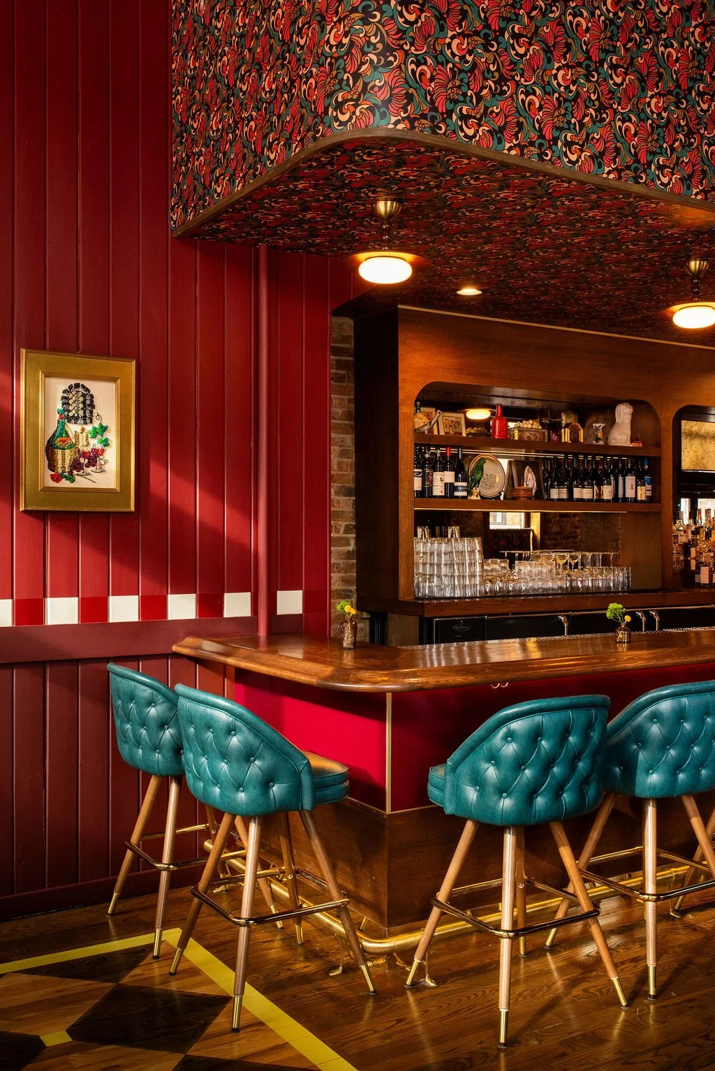 Corner bar with teal stools and patterned soffit at Dimmi Dimmi by Siren Betty Design.