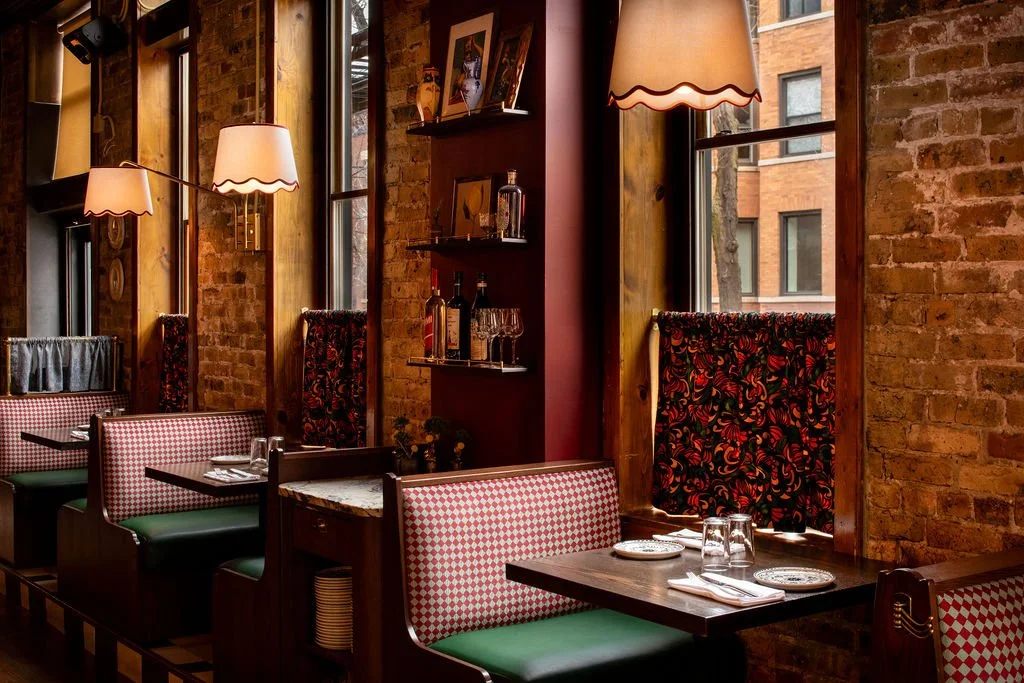 Window booth seating with checkered upholstery at Dimmi Dimmi by Siren Betty Design.