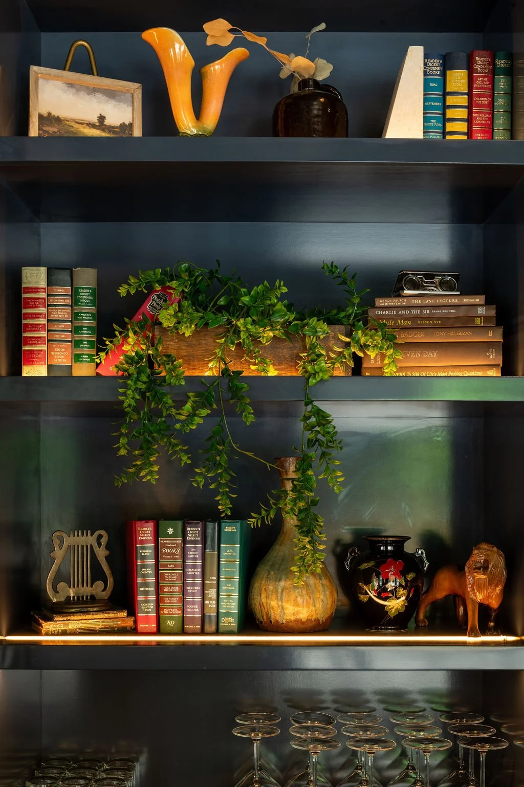 Art curation with vintage books, ceramics and greenery at Eaves by Siren Betty Design.