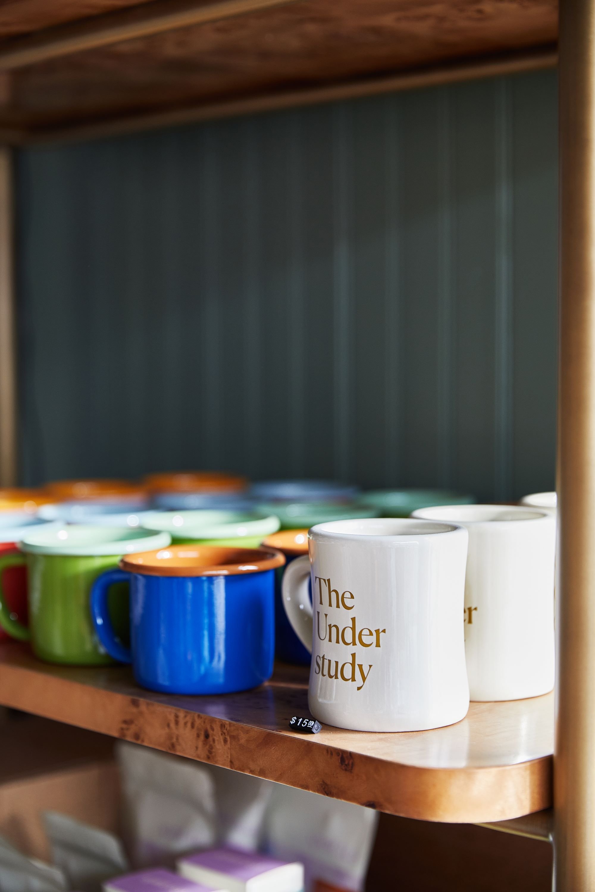 Custom coffee mugs on display with The Understudy logo detail by Siren Betty Design