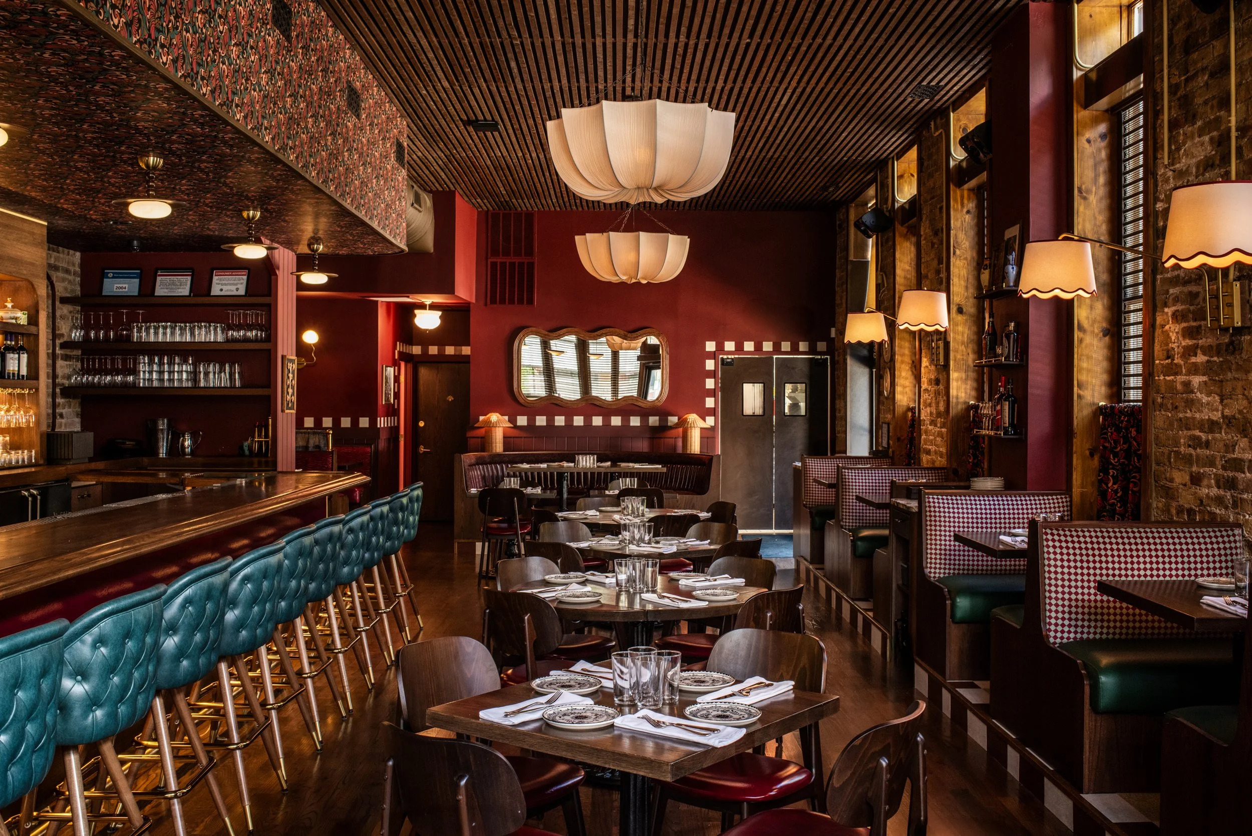 Dimmi Dimmi Chicago dining room with layered textures, lighting, patterned booths and teal bar stools by Siren Betty Design
