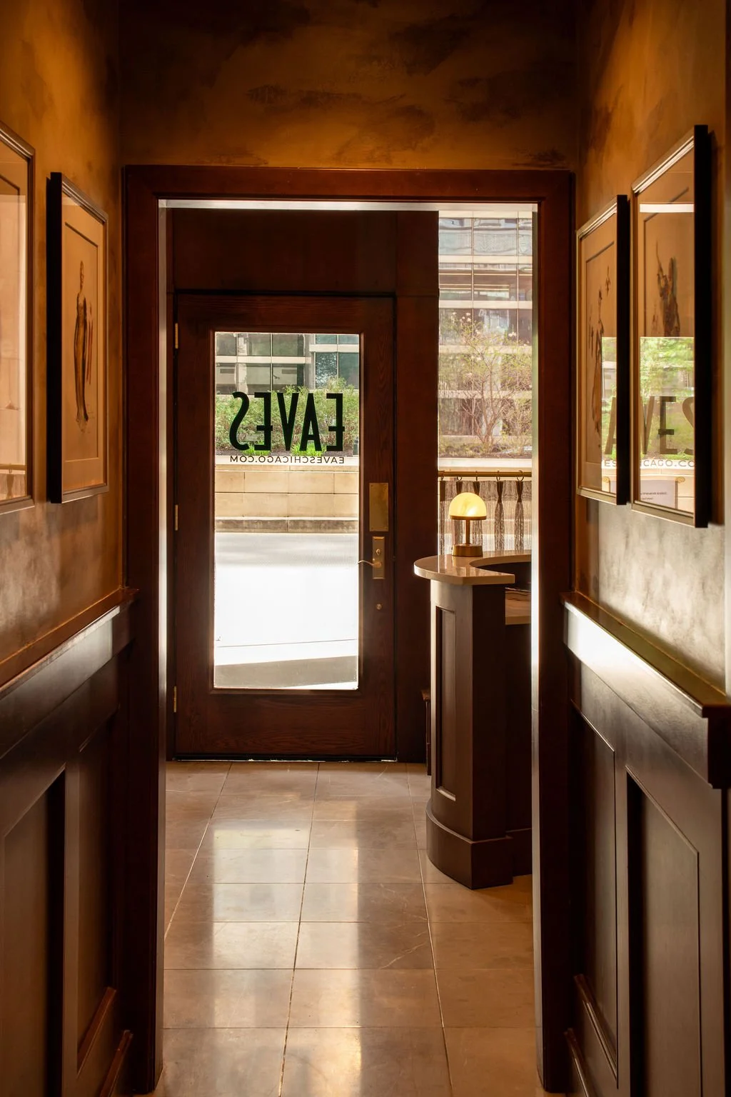 Eaves restaurant entrance at Chicago’s Lyric Opera House with dark wood paneling by Siren Betty Design.