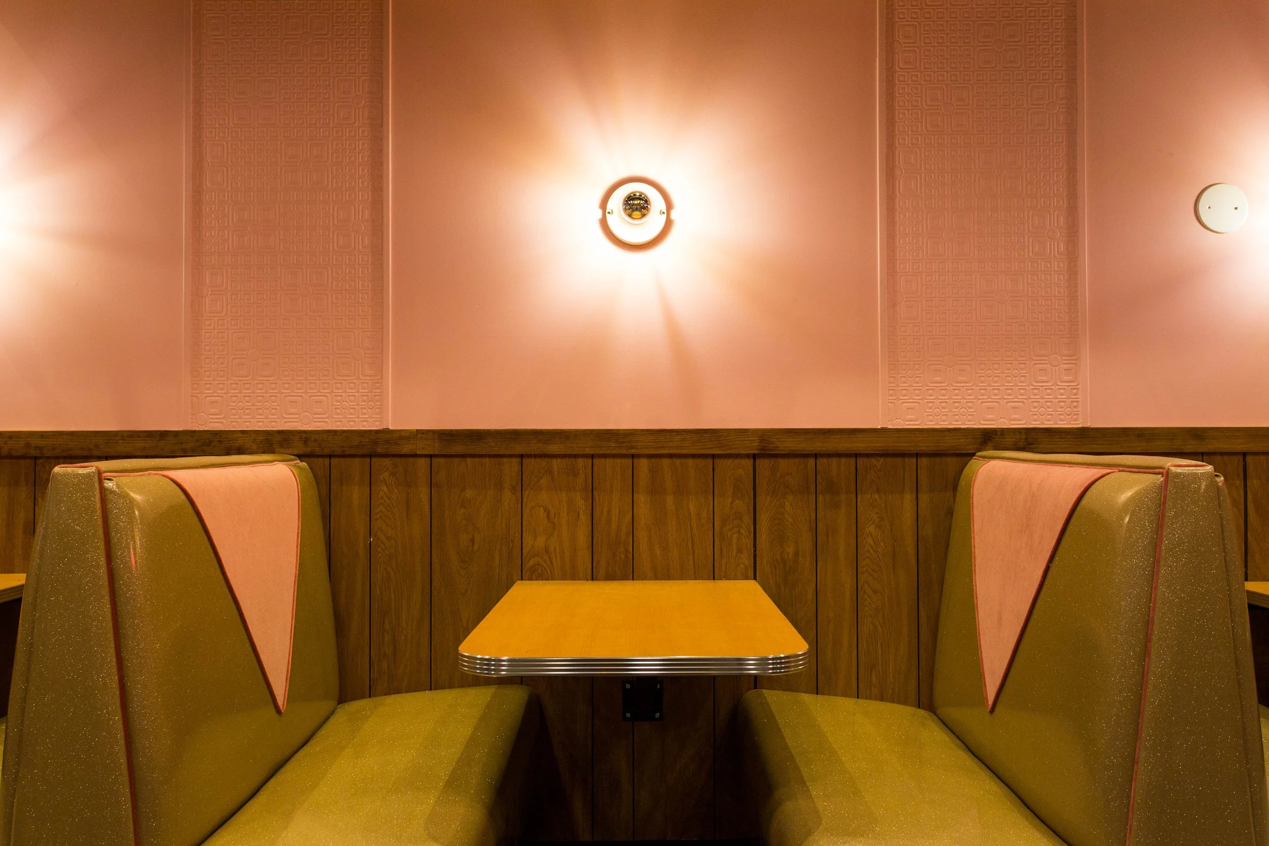 Pink Squirrel by Siren Betty Design, Chicago booth detail with pink walls, wood paneling, and vintage sparkle vinyl seating.