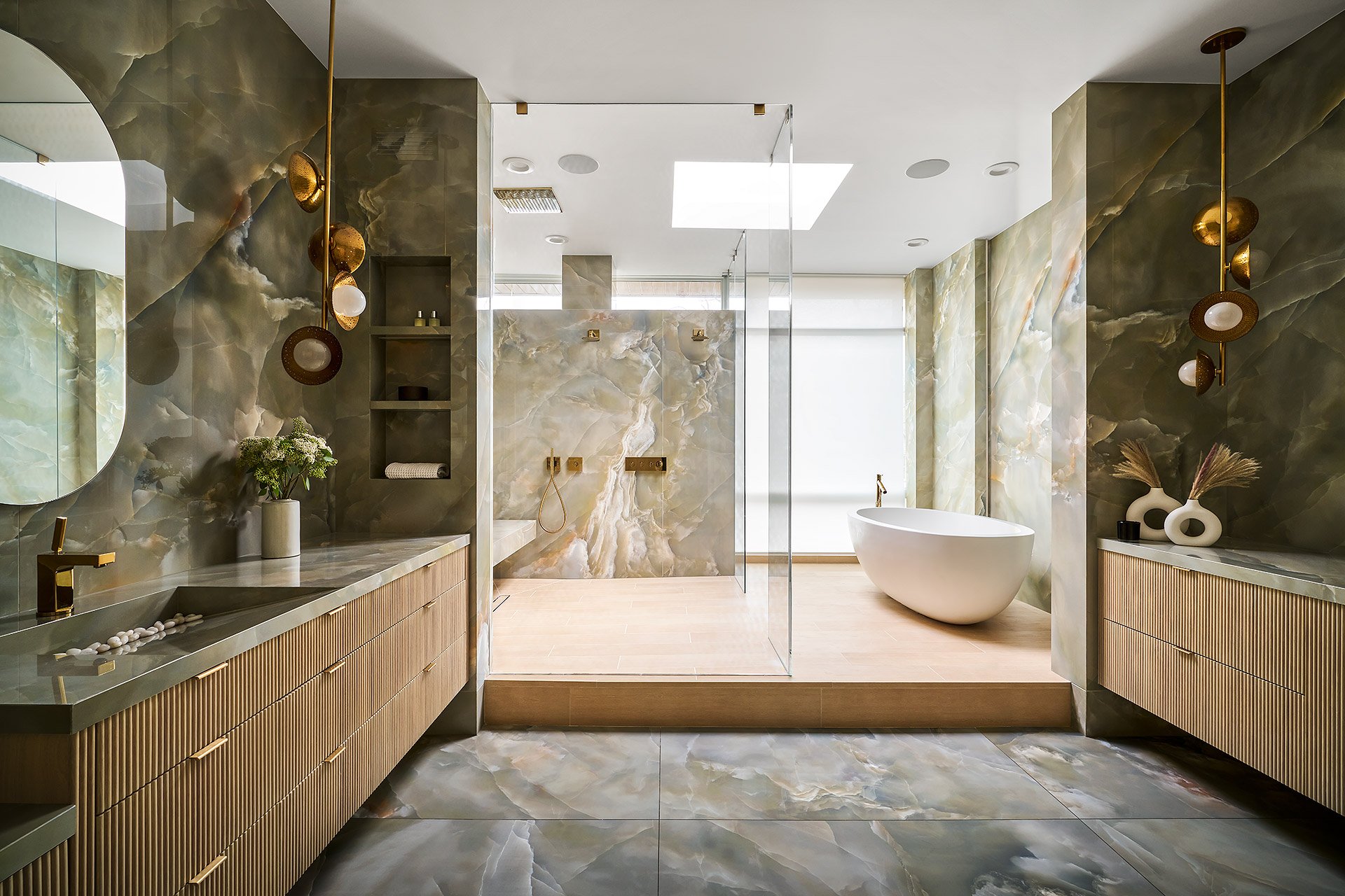 Private Residence bathroom with stone vanity, brass fixtures and walk-in shower by Siren Betty Design.