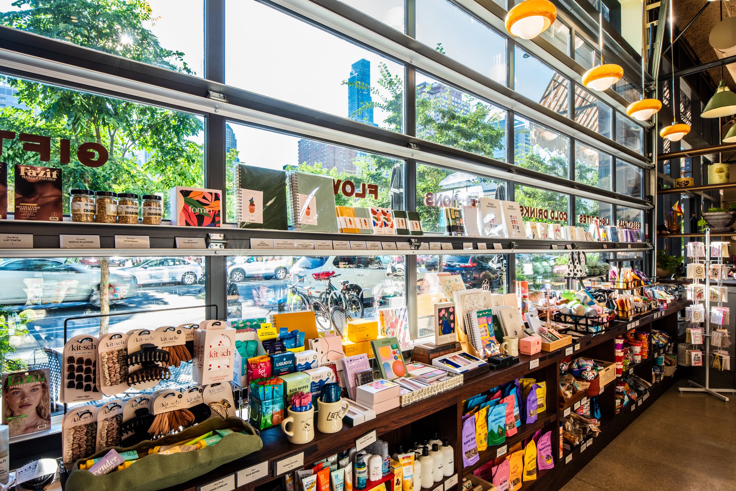 Layla and Ringo’s gift wall with cards, notebooks, snacks, and colorful products displayed along large bright windows