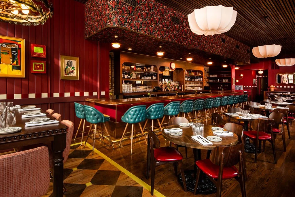 Dimmi Dimmi bar and dining room with teal bar stools and patterned flooring by Siren Betty Design.