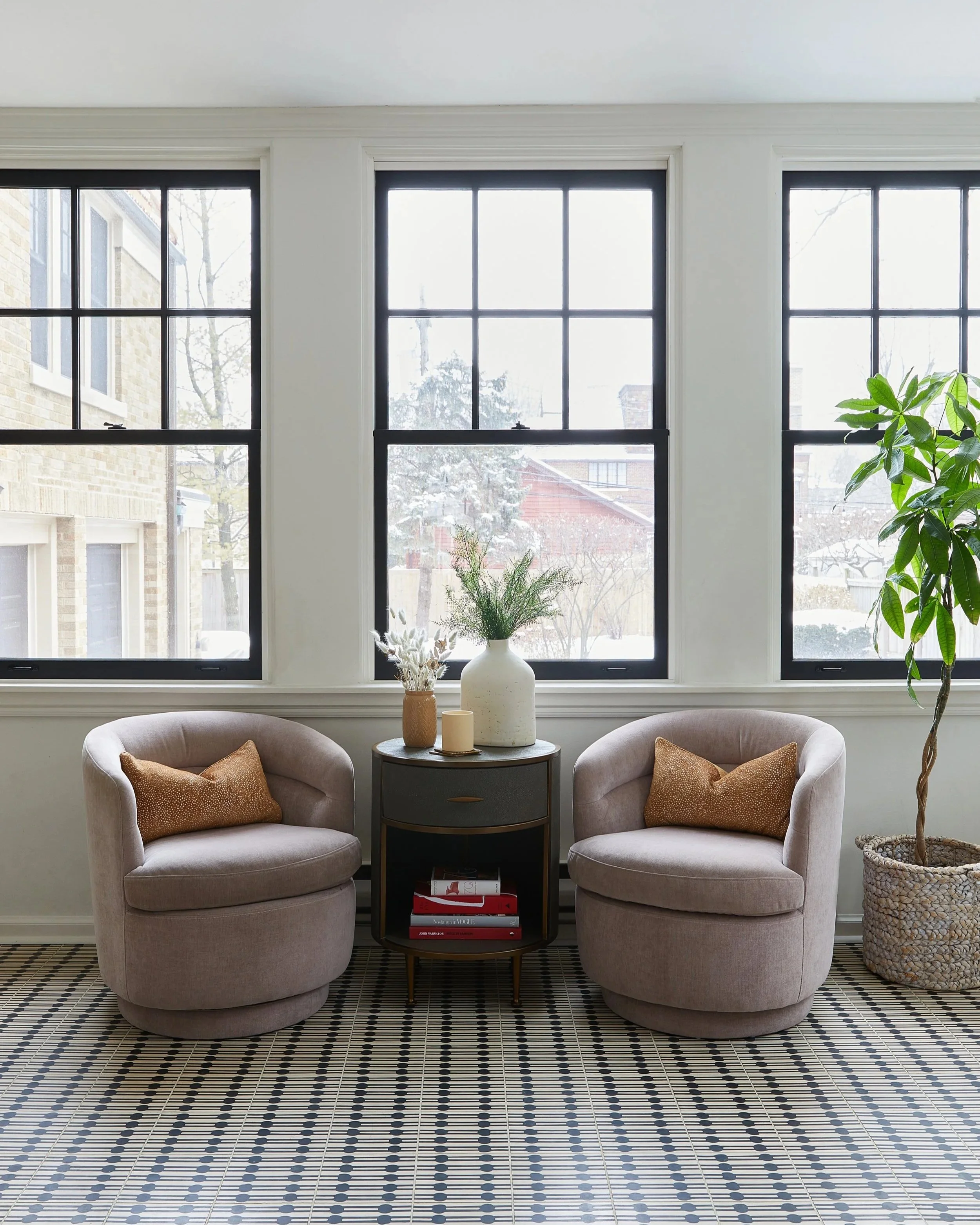 The Singer residential living room featuring a neutral palette with a textured rug by Siren Betty Design.