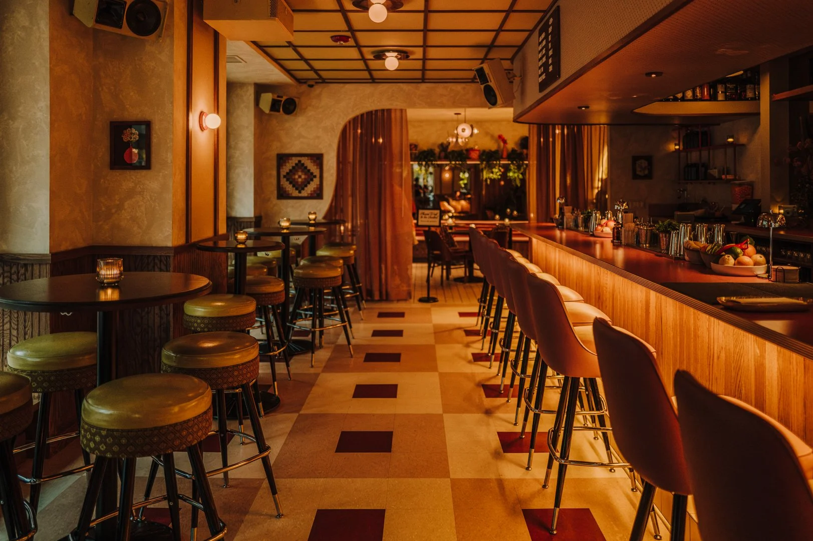 Double Fun bar interior with curved wood bar and seating designed by Siren Betty Design