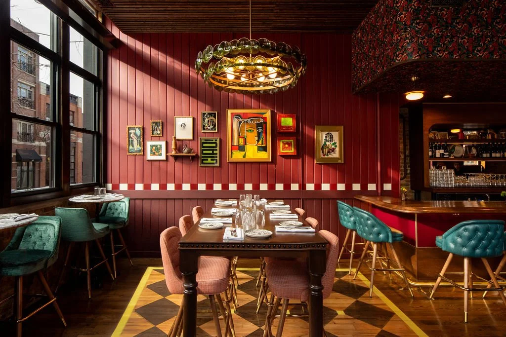 Dimmi Dimmi restaurant interior with warm lighting, teal bar stools, patterned booths by Siren Betty Design