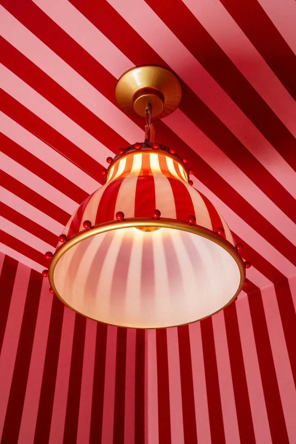 Striped pendant lighting in restroom at Dimmi Dimmi by Siren Betty Design.