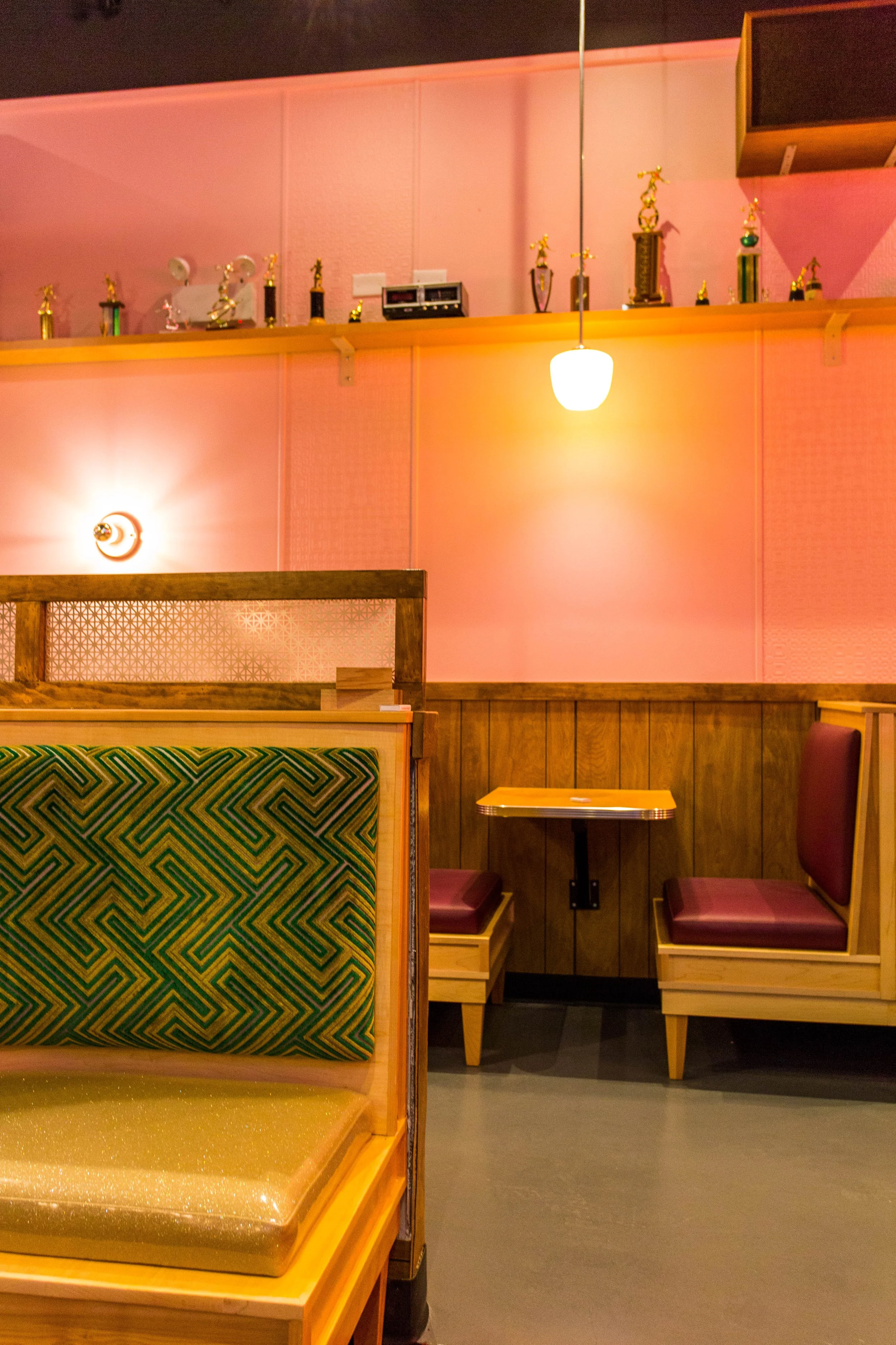 Pink Squirrel by Siren Betty Design, Chicago bar with vinyl booths, pink walls, and brass globe light fixtures.