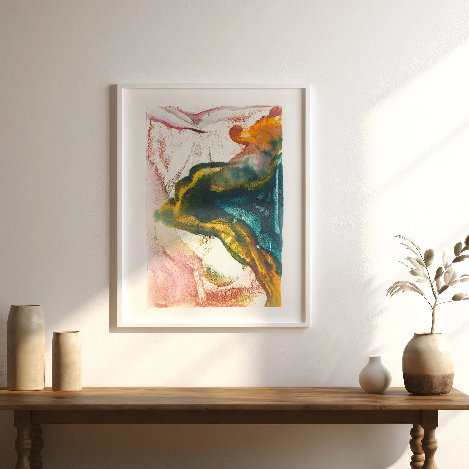 Bloom by Melissa McGill displayed above a wood table in a light-filled neutral interior, showing turquoise, green, yellow, orange, and pink abstract forms.