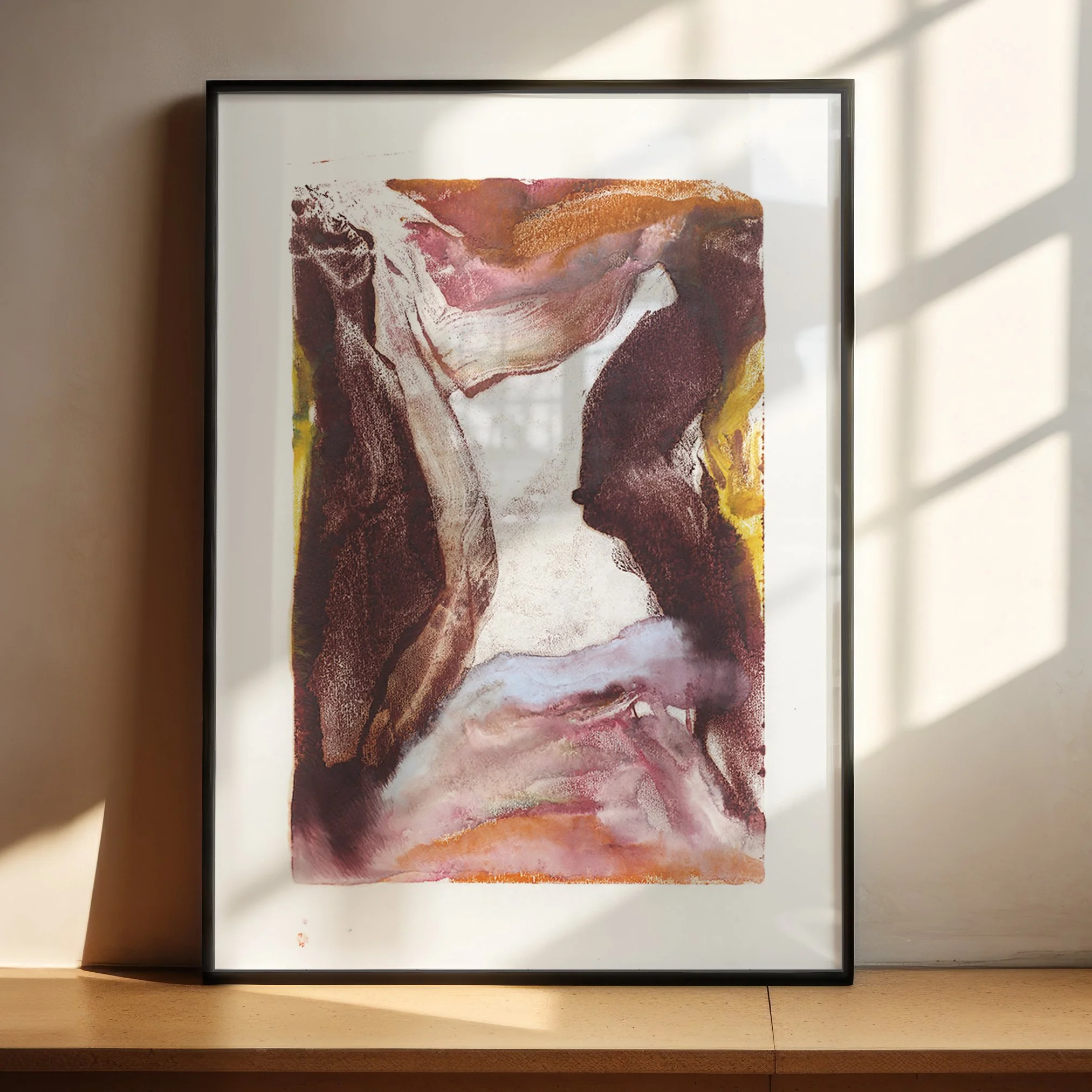 Erosion by Melissa McGill displayed in a black frame on a sunlit wooden shelf, with dark burgundy forms enclosing a pale passage above flowing pink and lavender textures.