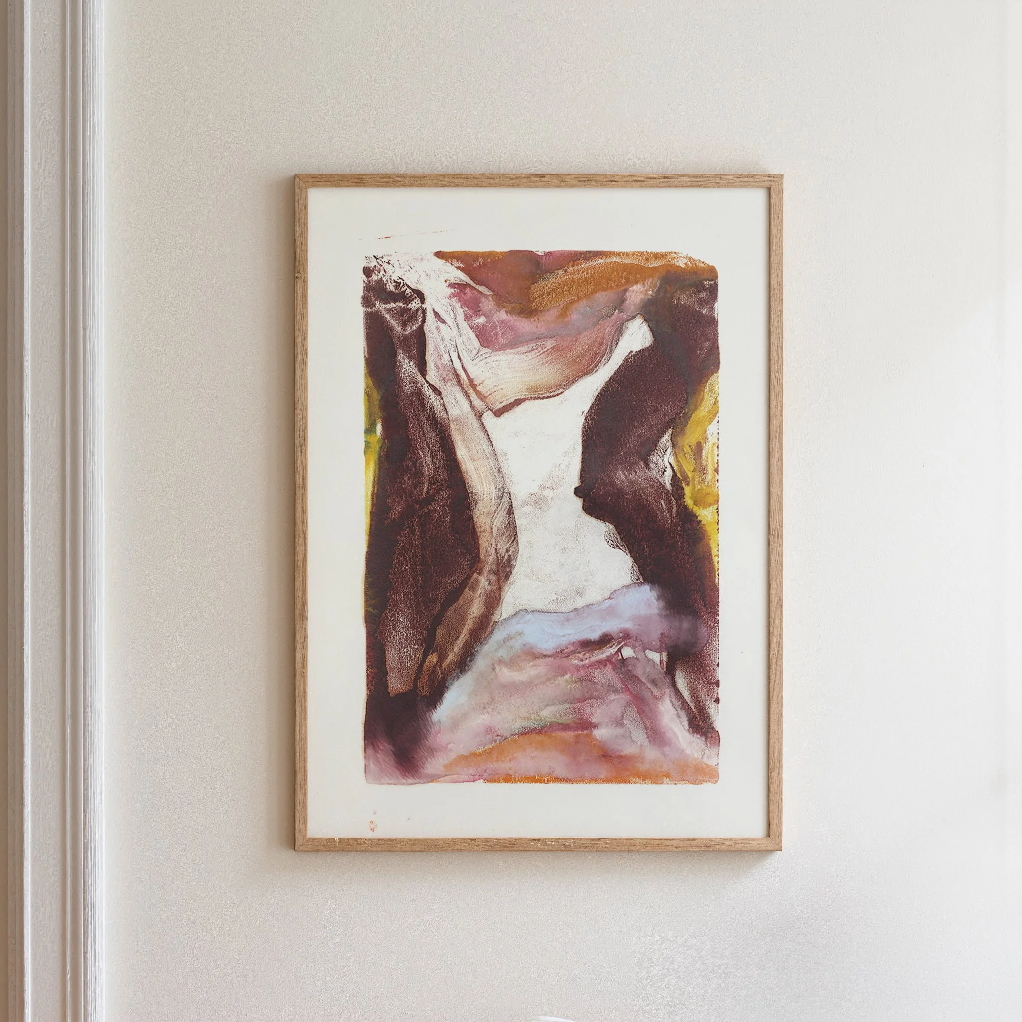 Erosion by Melissa McGill displayed in a natural wood frame on a white wall, showing burgundy and brown vertical forms, golden yellow accents, and a luminous central opening.