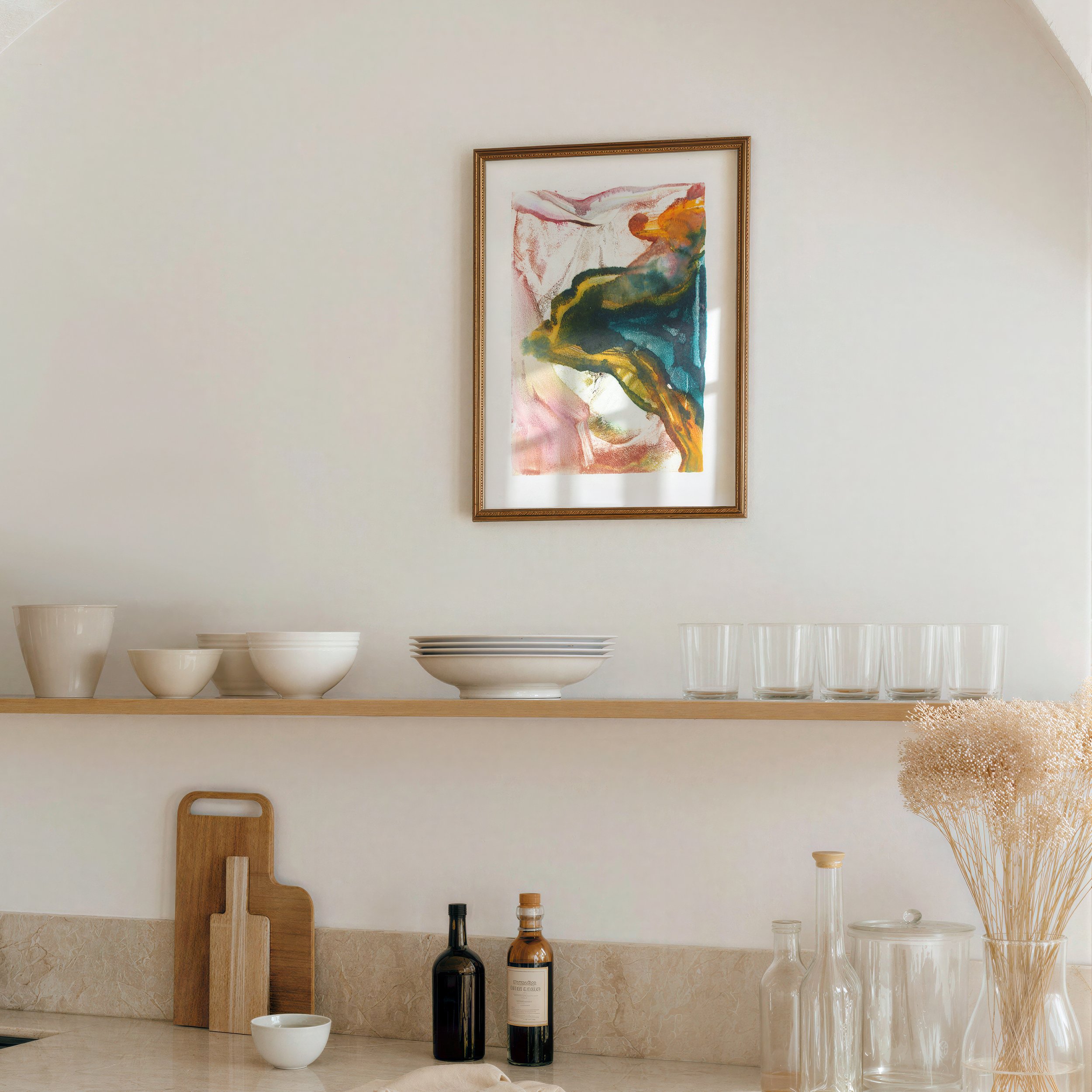 Bloom by Melissa McGill displayed in a decorative gold frame above open shelving in a warm neutral kitchen.