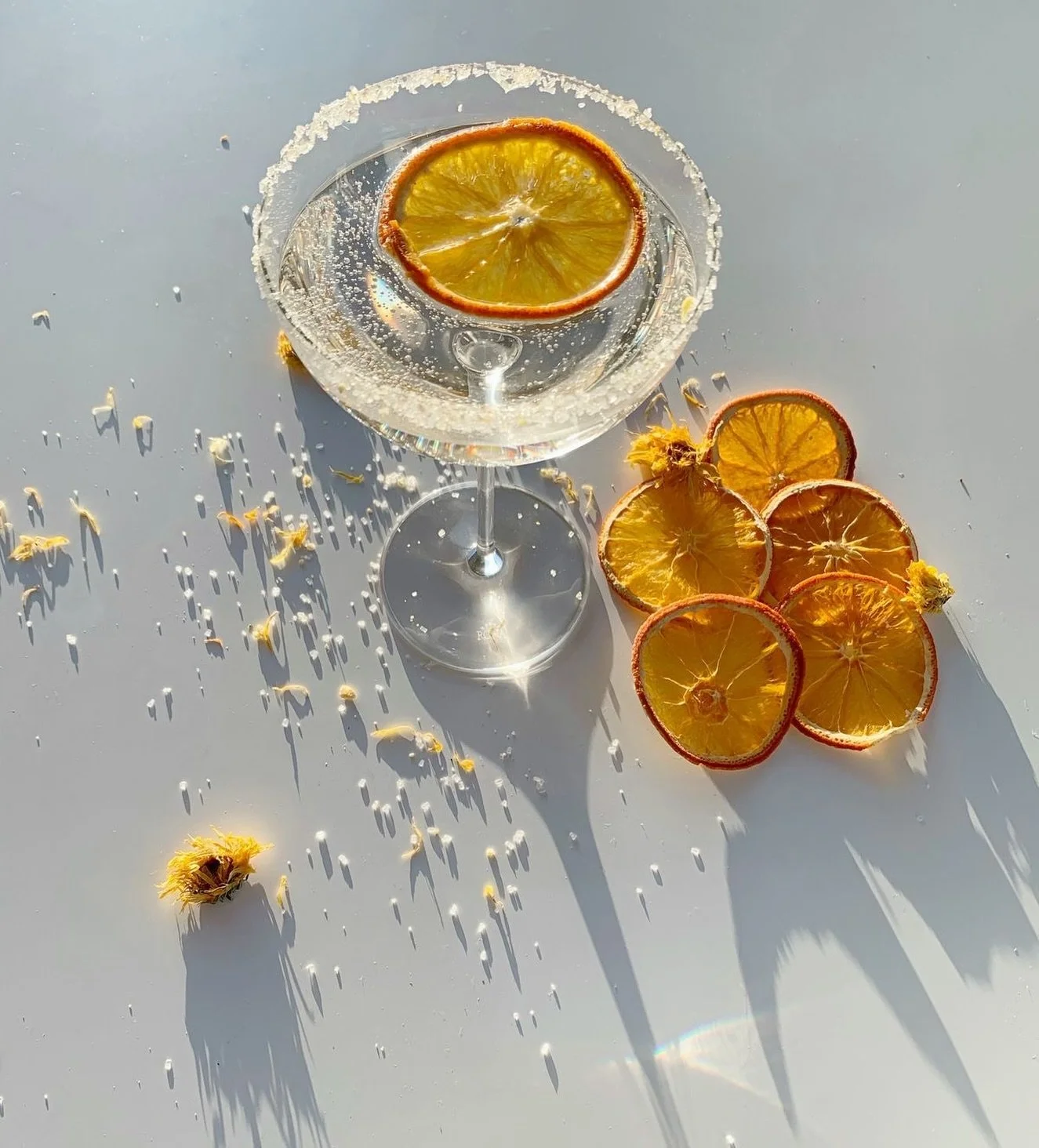 Summer Spritz, but make it city chic.
 🍊☀️ Try this Garnish Game Summer Spritz:
	&bull;	45ml gin
	&bull;	15ml elderflower liqueur
	&bull;	15ml fresh lime juice
	&bull;	Top with soda or sparkling wine
	&bull;	Zesty Citrus Sugar rim + dehydrated orang