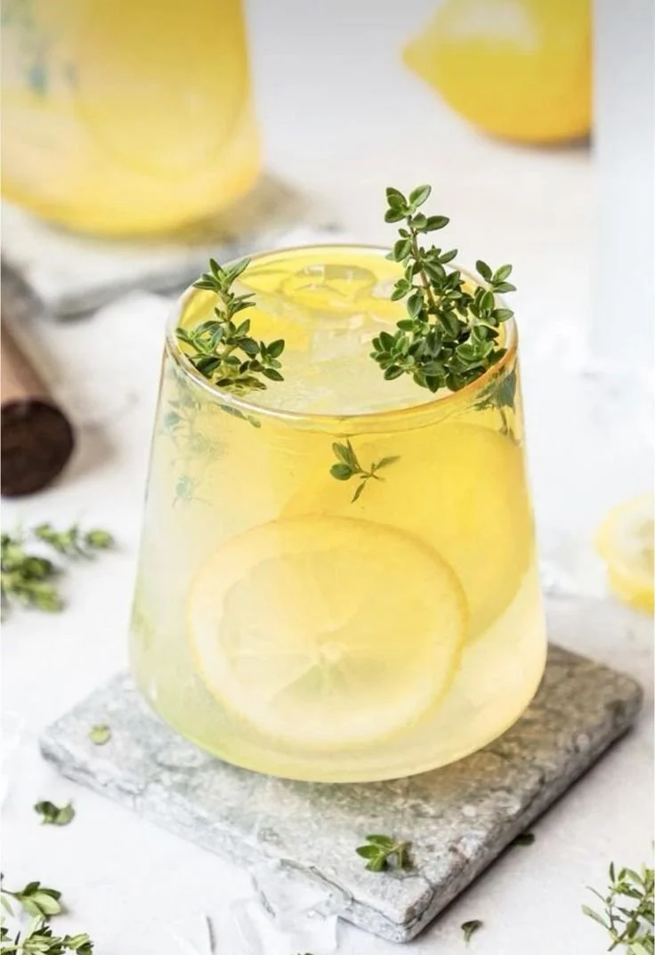 a cocktail with a small bunch of fresh herbs 