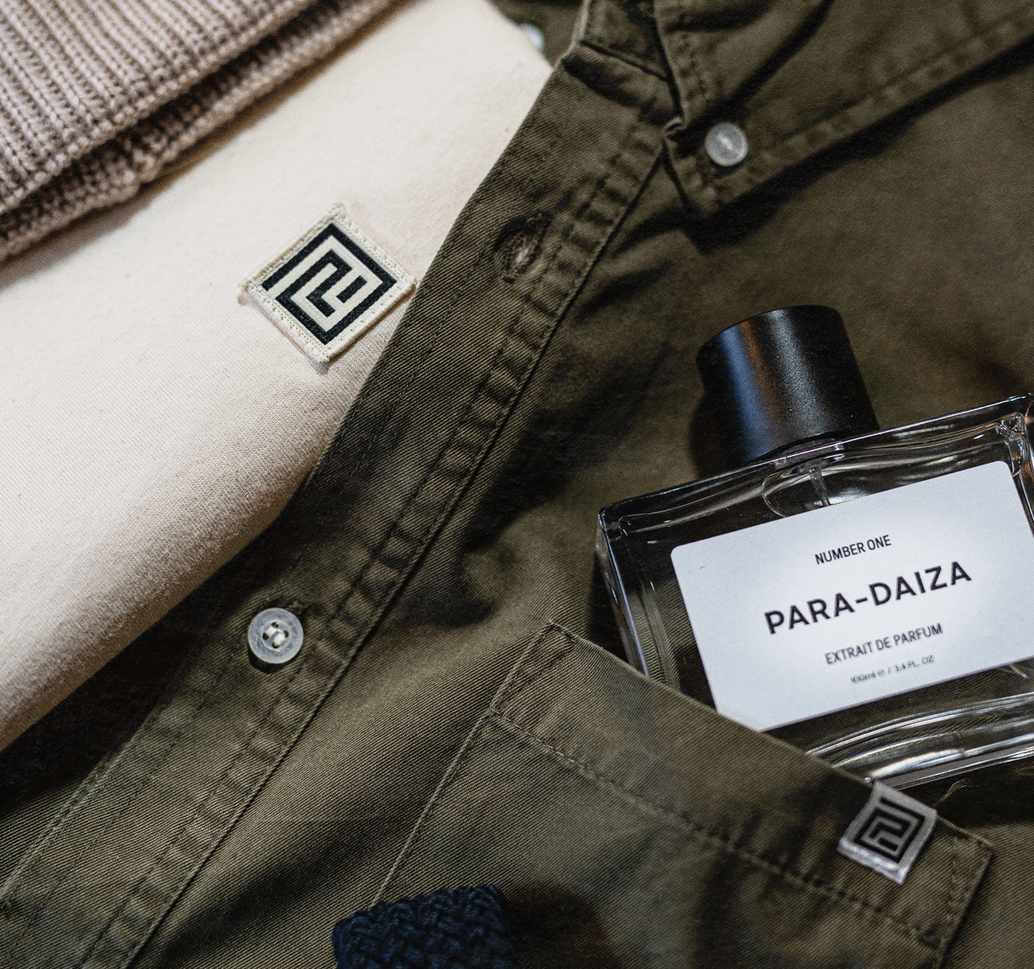 Paradaiza branding showing the logo in situ against the upcycled, demilitarised fashion garments. Logo design by Asa Rodger from Page®.