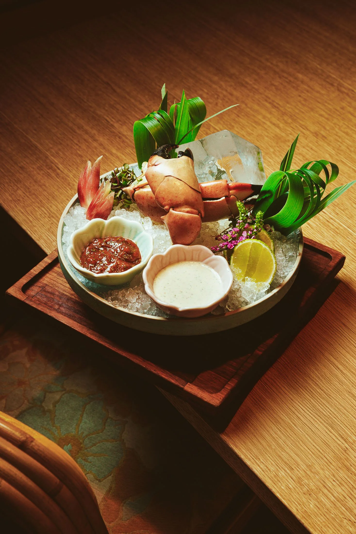 Fine dining seafood platter photography at Makoto Miami featuring oysters and crab legs in a raw bar presentation.