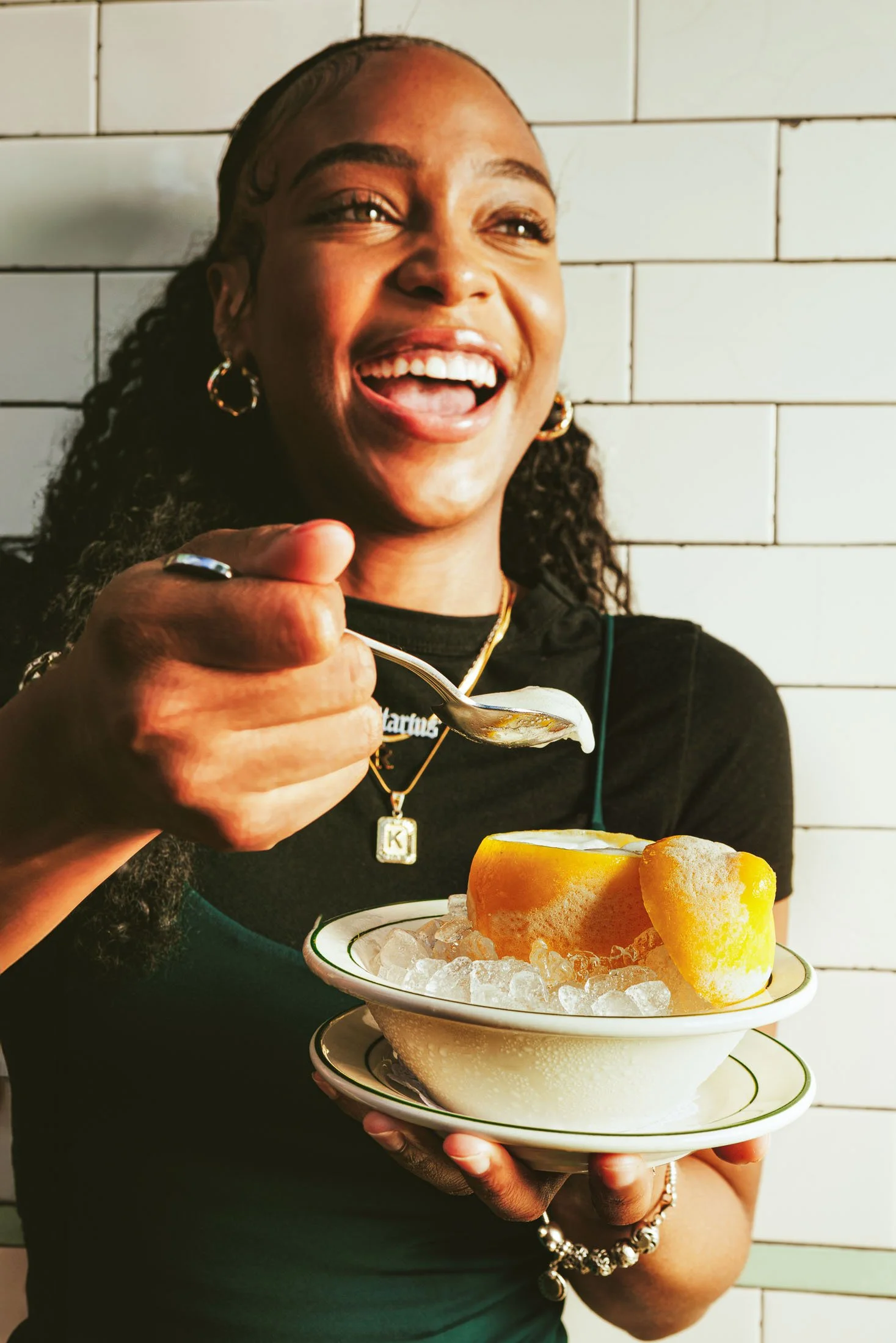 Restaurant lifestyle photography at Pastis Miami showing a woman enjoying a lemon ice cream dessert