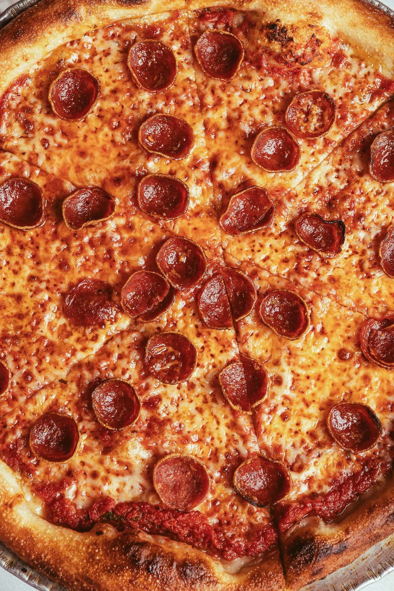 Restaurant dining experience photography featuring pizza and cocktails shared on a table in Miami