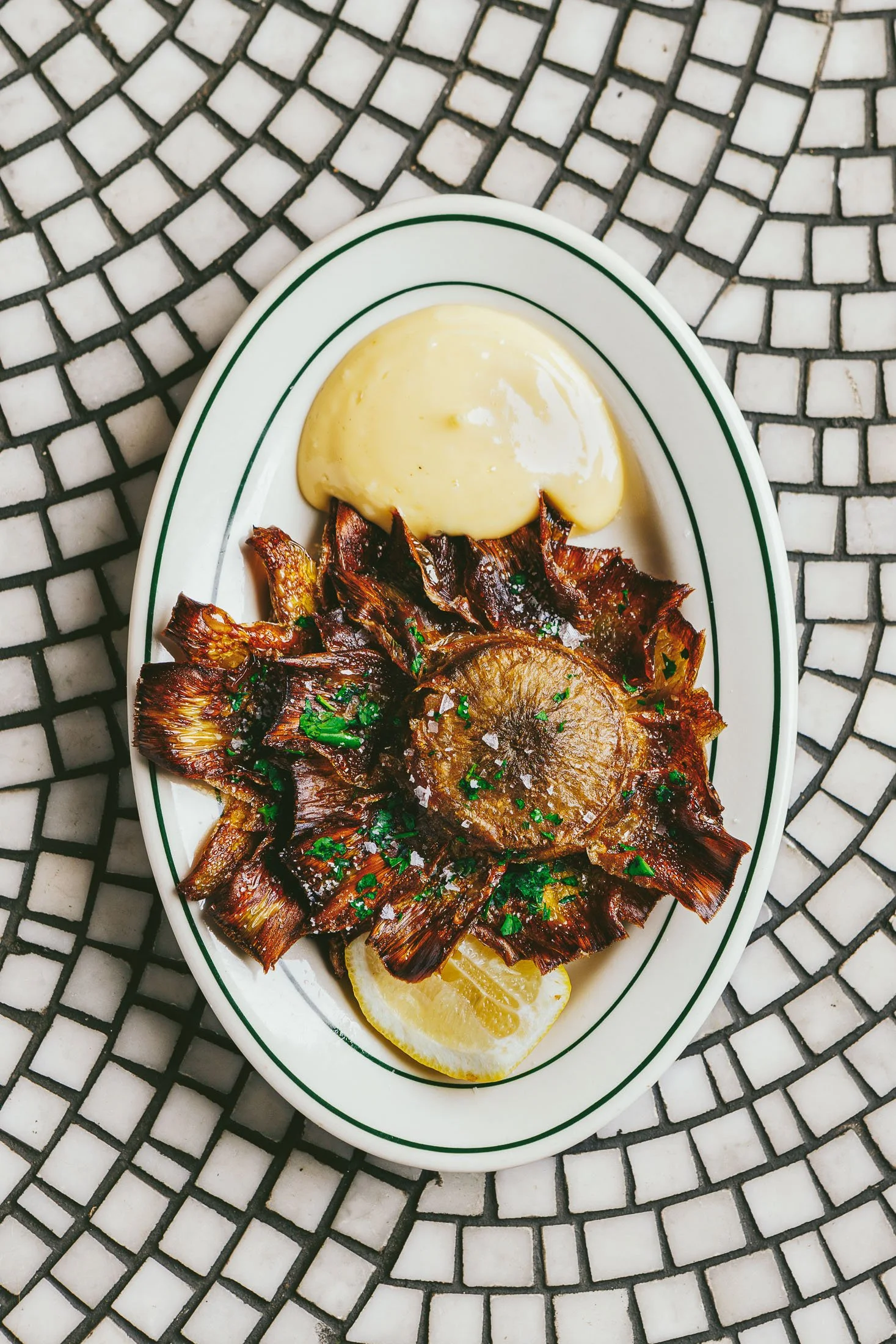 Fine dining French food photography at Pastis Miami featuring artichoke with elegant plating