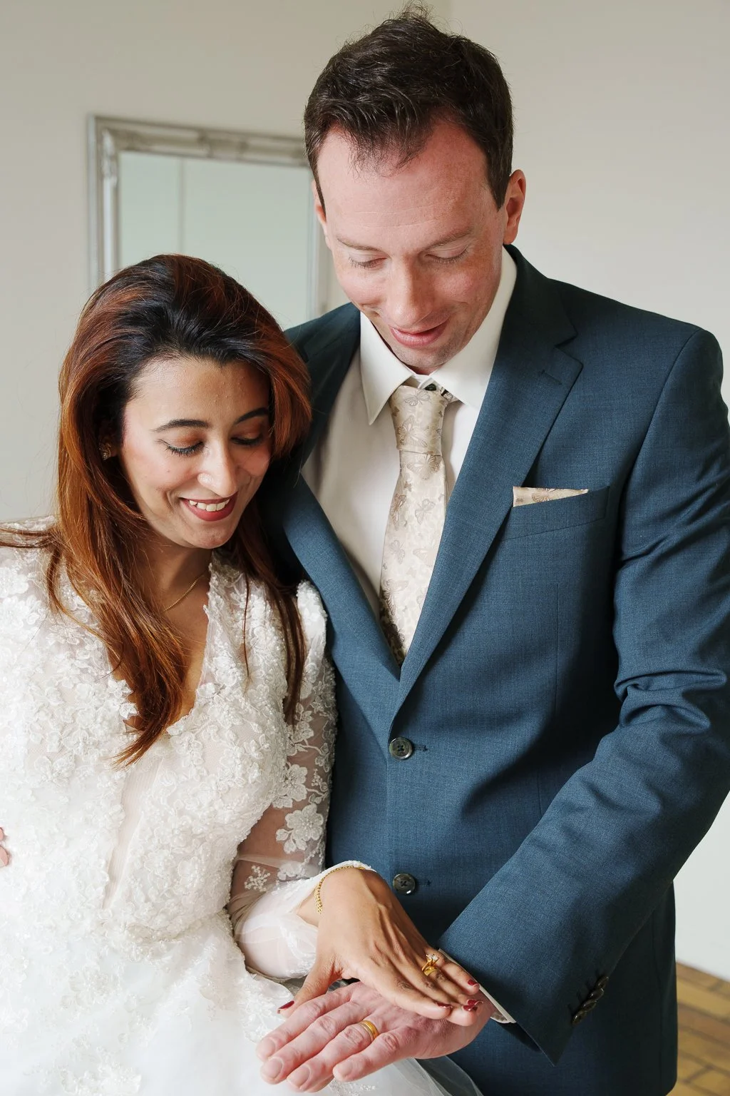Wedding couple smiling and looking at  their wedding rings after civil wedding at Aeroe City Hall.