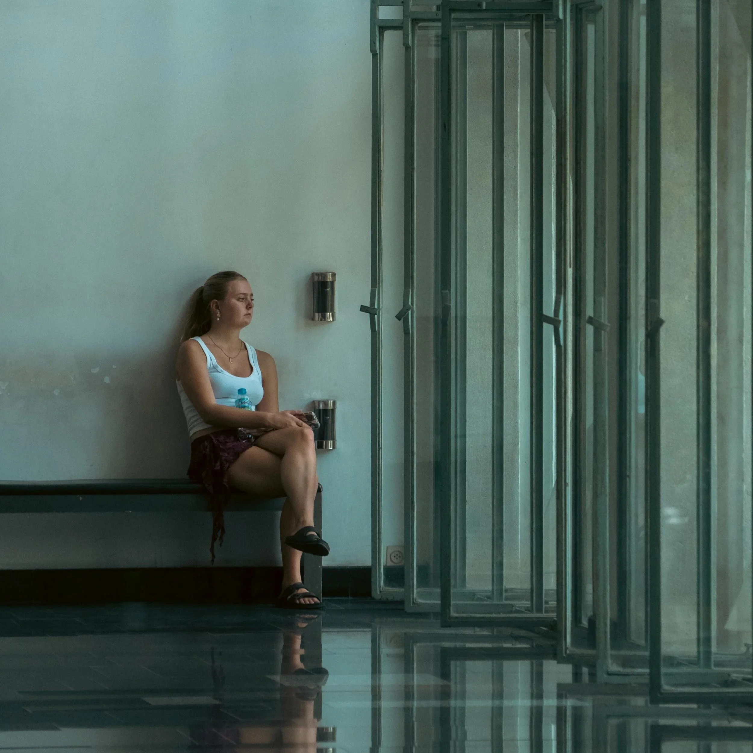 Woman sitting quietly alone, eyes closed, representing the emotional weight of perimenopause and menopause addressed in therapy in California