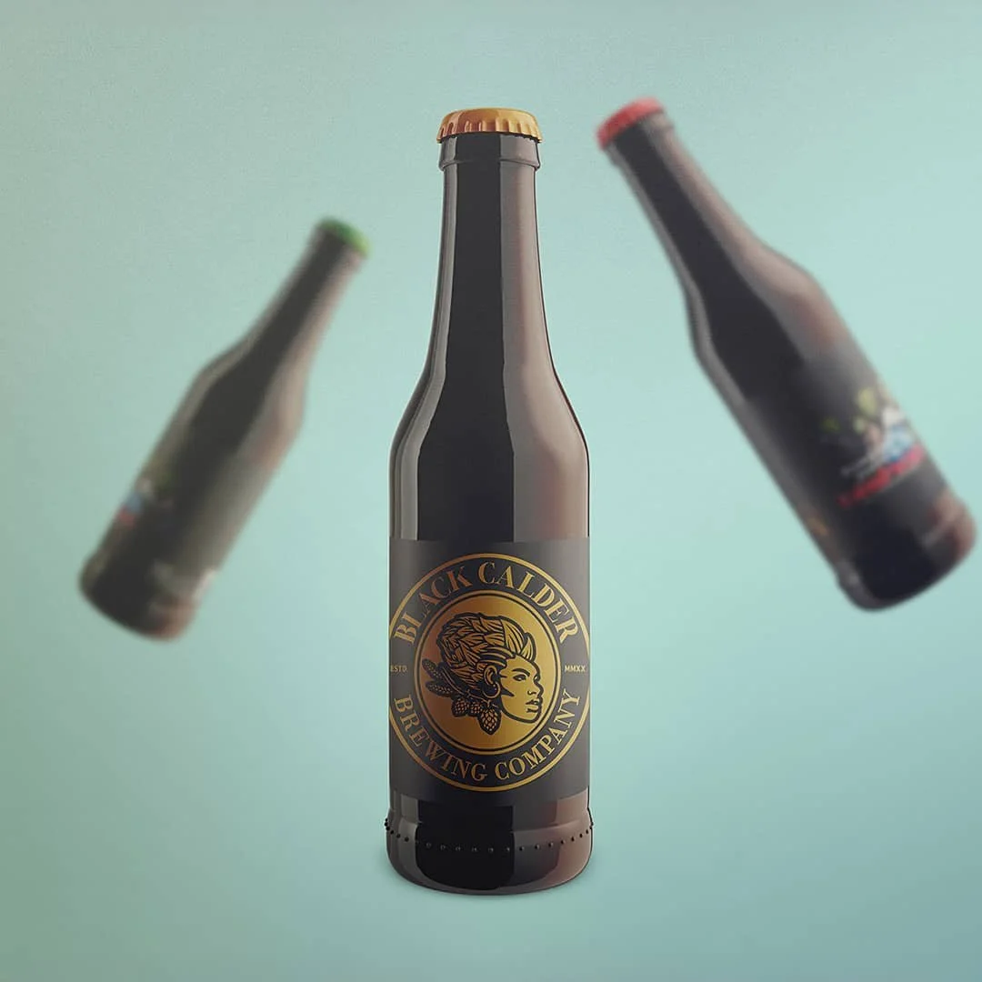 Black Calder Brewing Company beer bottles creative product photography with motion blur teal background