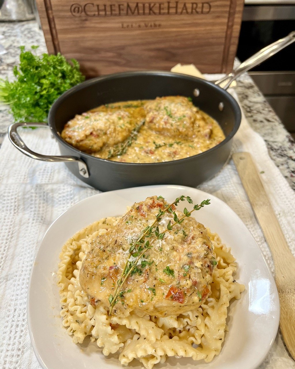 Marry Me Chicken in pan in background with plated dish with pasta in front