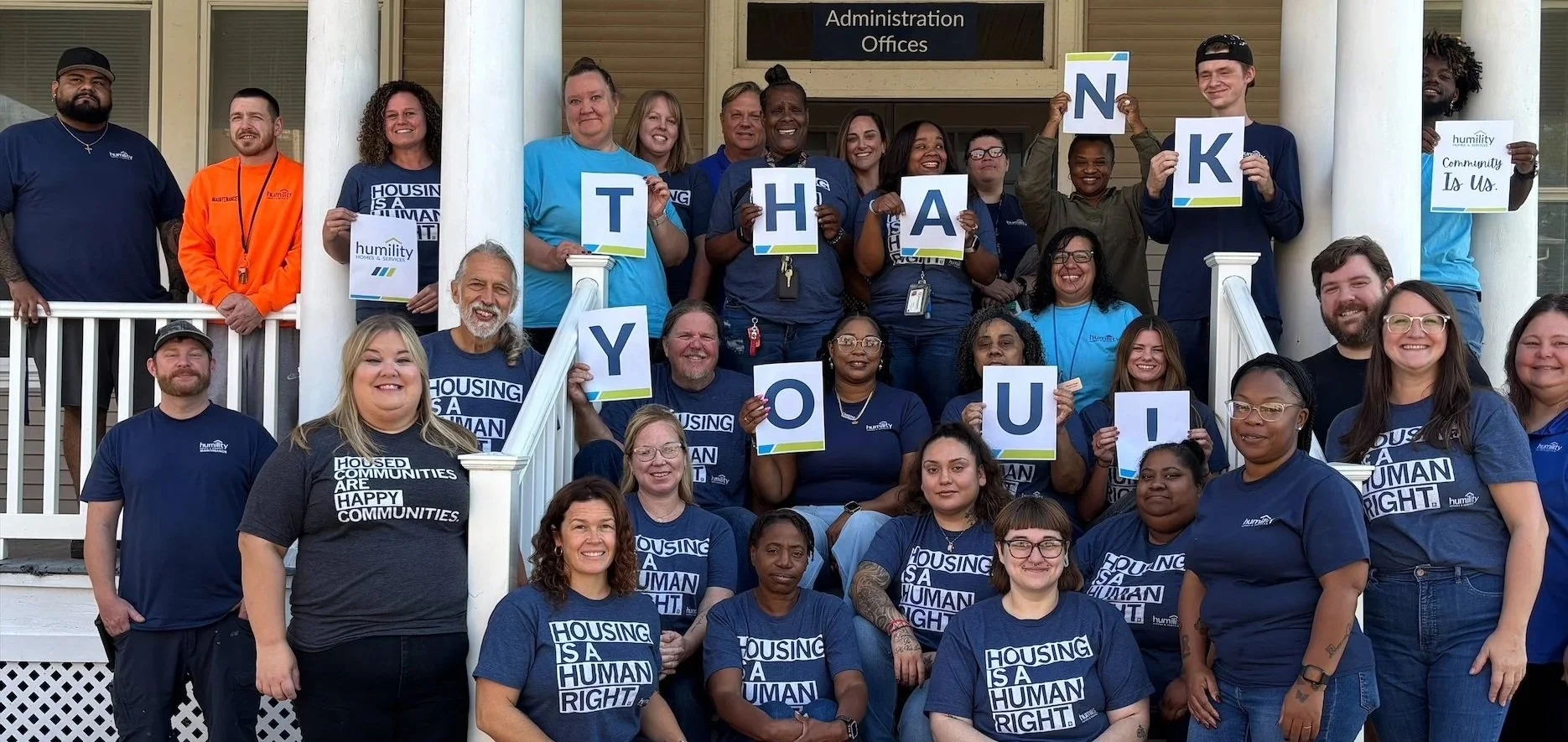 Humility Homes and Services staff holding Thank You signs