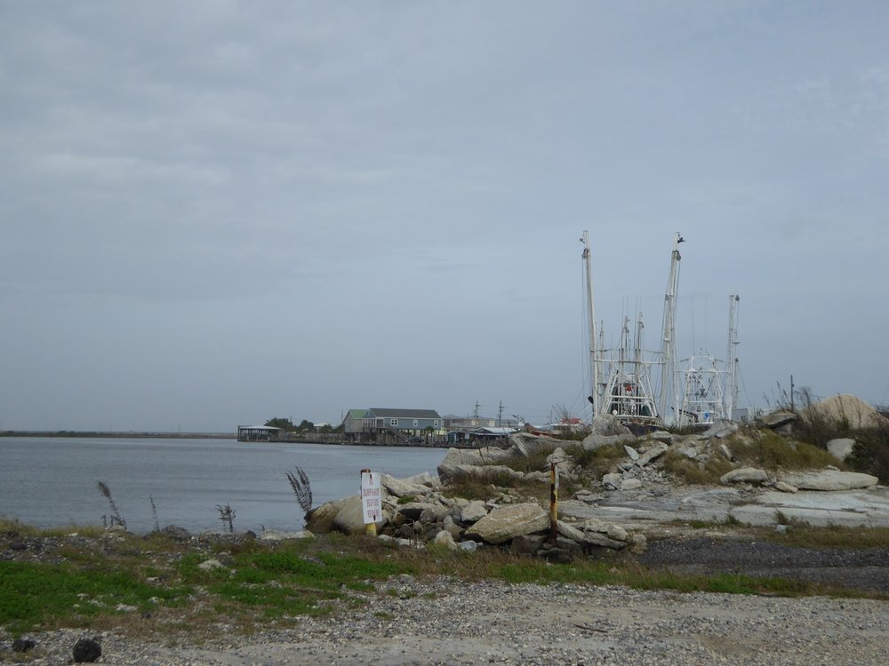  Near Port Fourchon, a marina and piles of gravel    