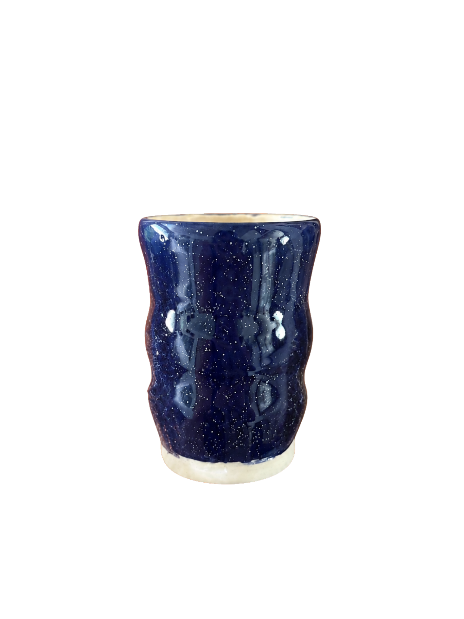 Handcrafted ceramic cup with a deep midnight-blue speckled glaze, sculpted sides, and natural ceramic base