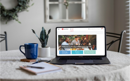laptop on wooden desk open to front page of a learning portal