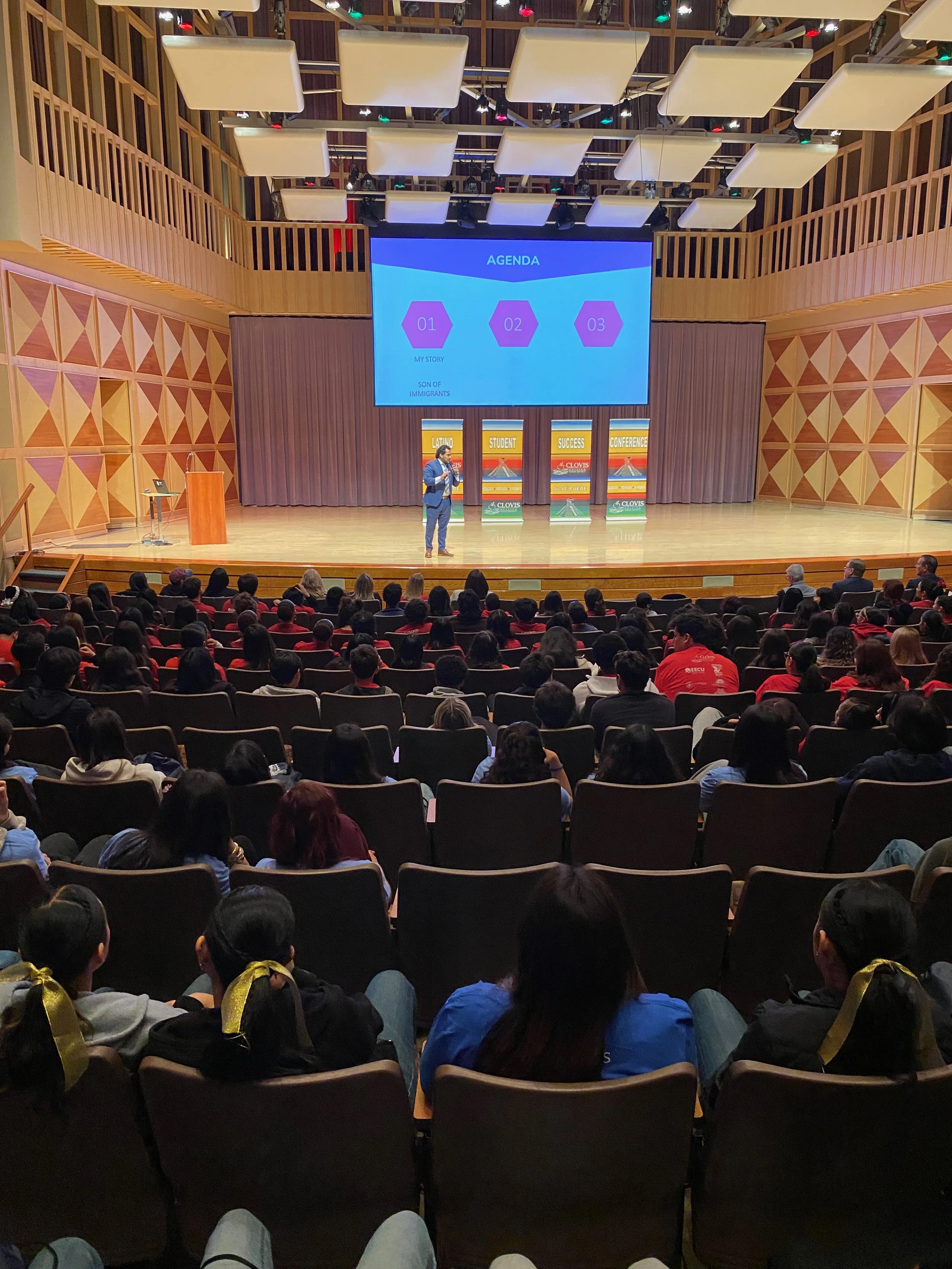 Image of man speaking in an auditorium.